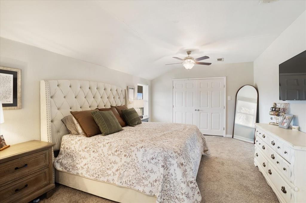 90 Williams Trail Howe, TX 75459 - Photo 9 of 18 a bedroom with a bed and a chandelier