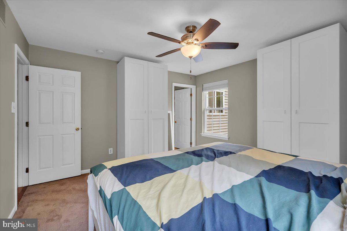 48 Country Club Road Pine Hill, NJ 08021 - Photo 24 of 40 a bedroom with a bed and a chandelier