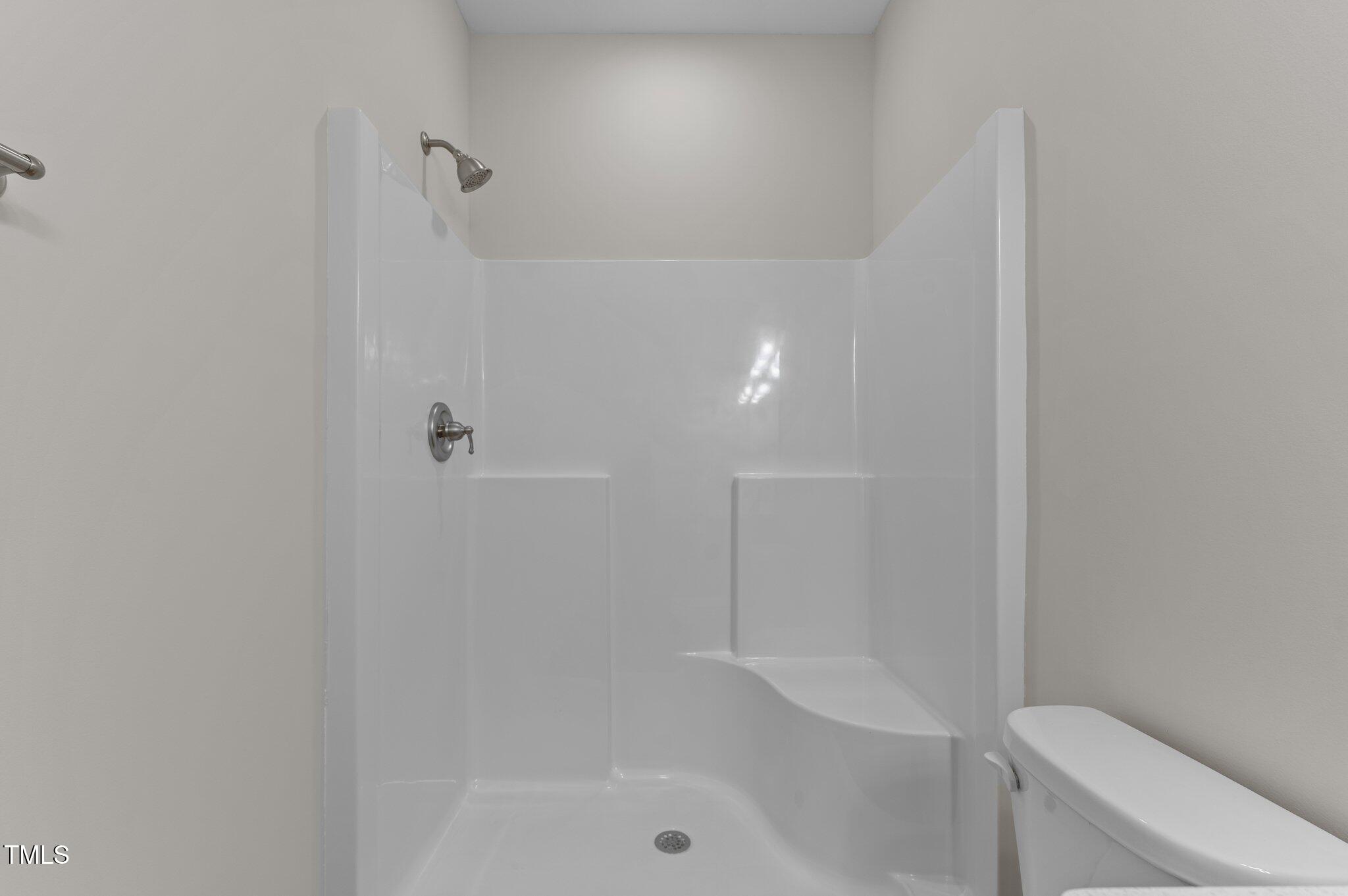170 Brookhaven Drive Spring Hope, NC 27882 - Photo 15 of 31 a bathroom with a shower a toilet and sink