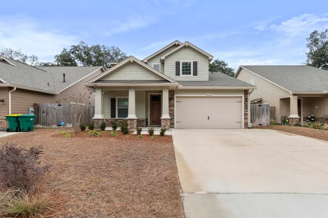 a front view of a house with yard and porch