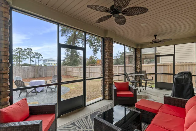 a living room with furniture and a floor to ceiling window