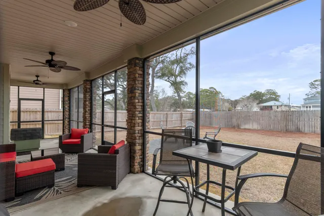 a view of a chairs and tables in the back yard of the house