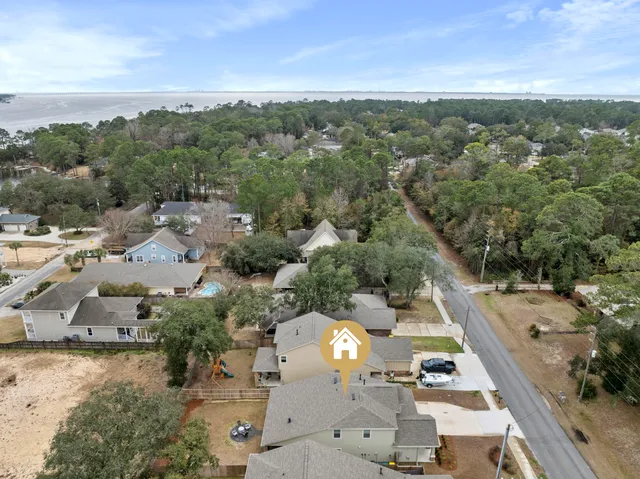 an aerial view of a house with a yard