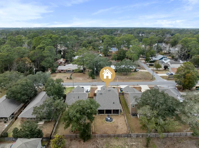 an aerial view of residential building with outdoor space and ocean view