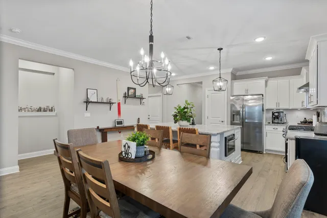 a view of a dining room and chandelier furniture and wooden floor