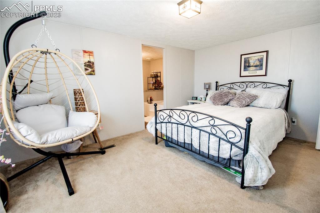 1880 Johnson Road North Rush, CO 80833 - Photo 11 of 40 a bedroom with a bed window table and chair