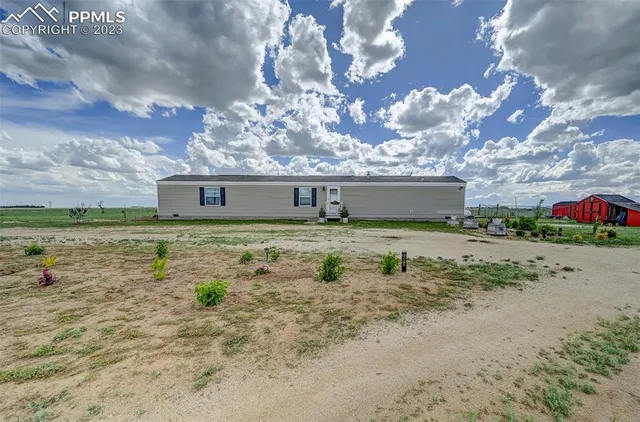 a view of a big yard with table and chairs