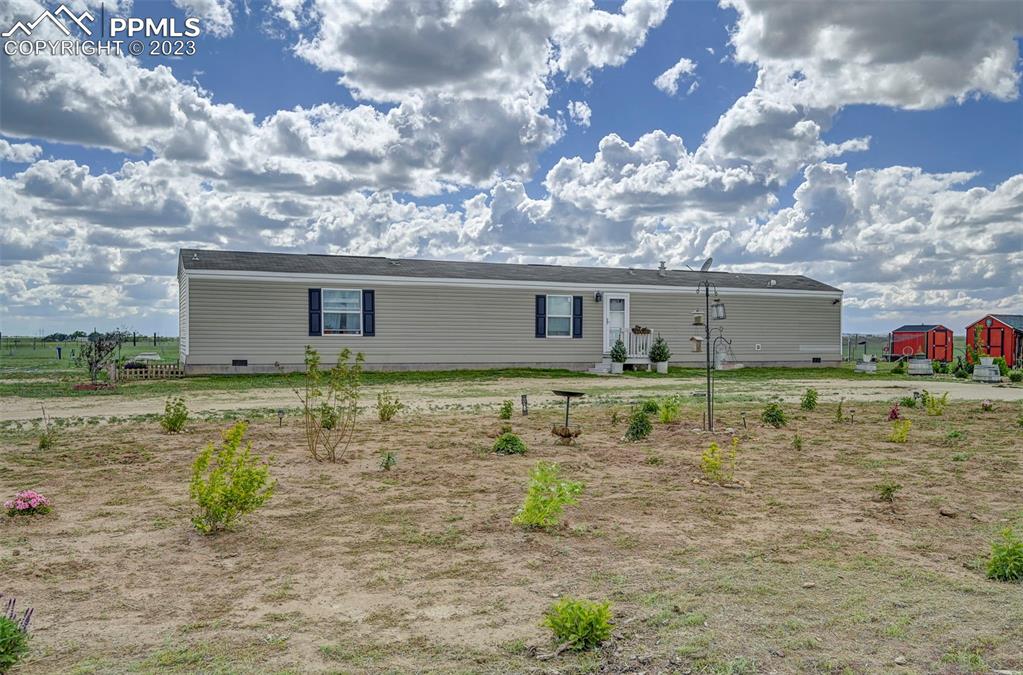 1880 Johnson Road North Rush, CO 80833 - Photo 29 of 40 a view of a house with a yard