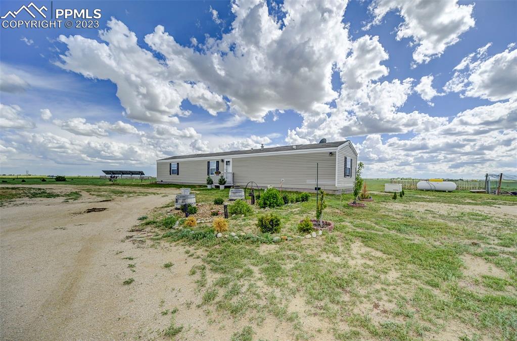 1880 Johnson Road North Rush, CO 80833 - Photo 32 of 40 front view of a house with a yard