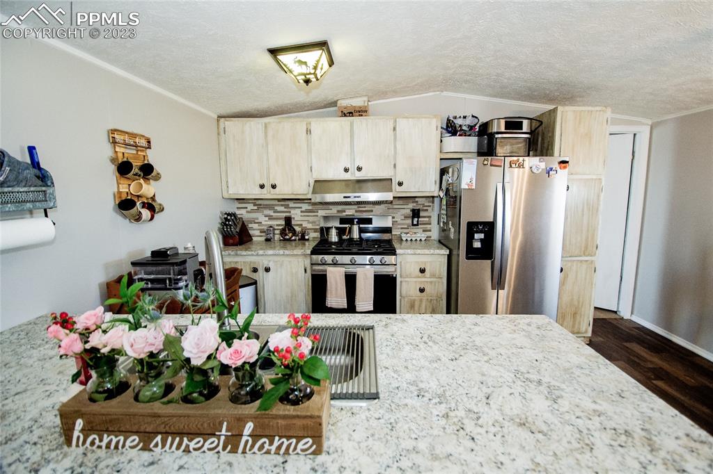 1880 Johnson Road North Rush, CO 80833 - Photo 10 of 40 a kitchen with stainless steel appliances granite countertop a refrigerator and a stove top oven