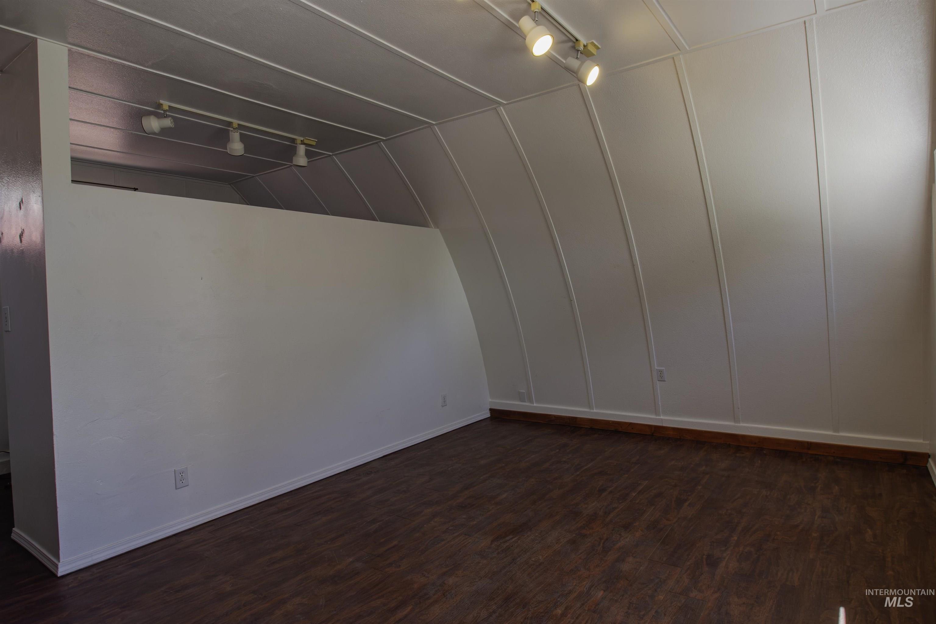 161 Southeast 5th Avenue Ontario, OR 97914 - Photo 13 of 41 Main room with dark wood-style floors, track lighting
