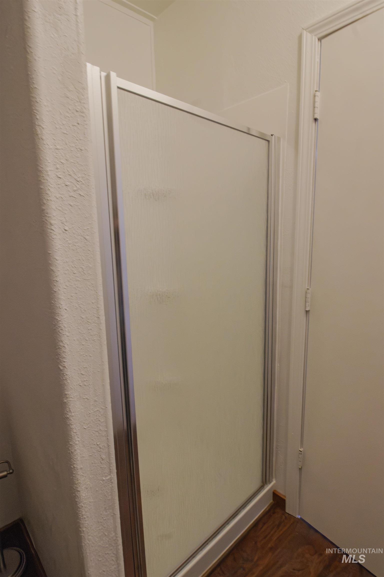 161 Southeast 5th Avenue Ontario, OR 97914 - Photo 19 of 41 Full bath featuring a stall shower and wood finished floors