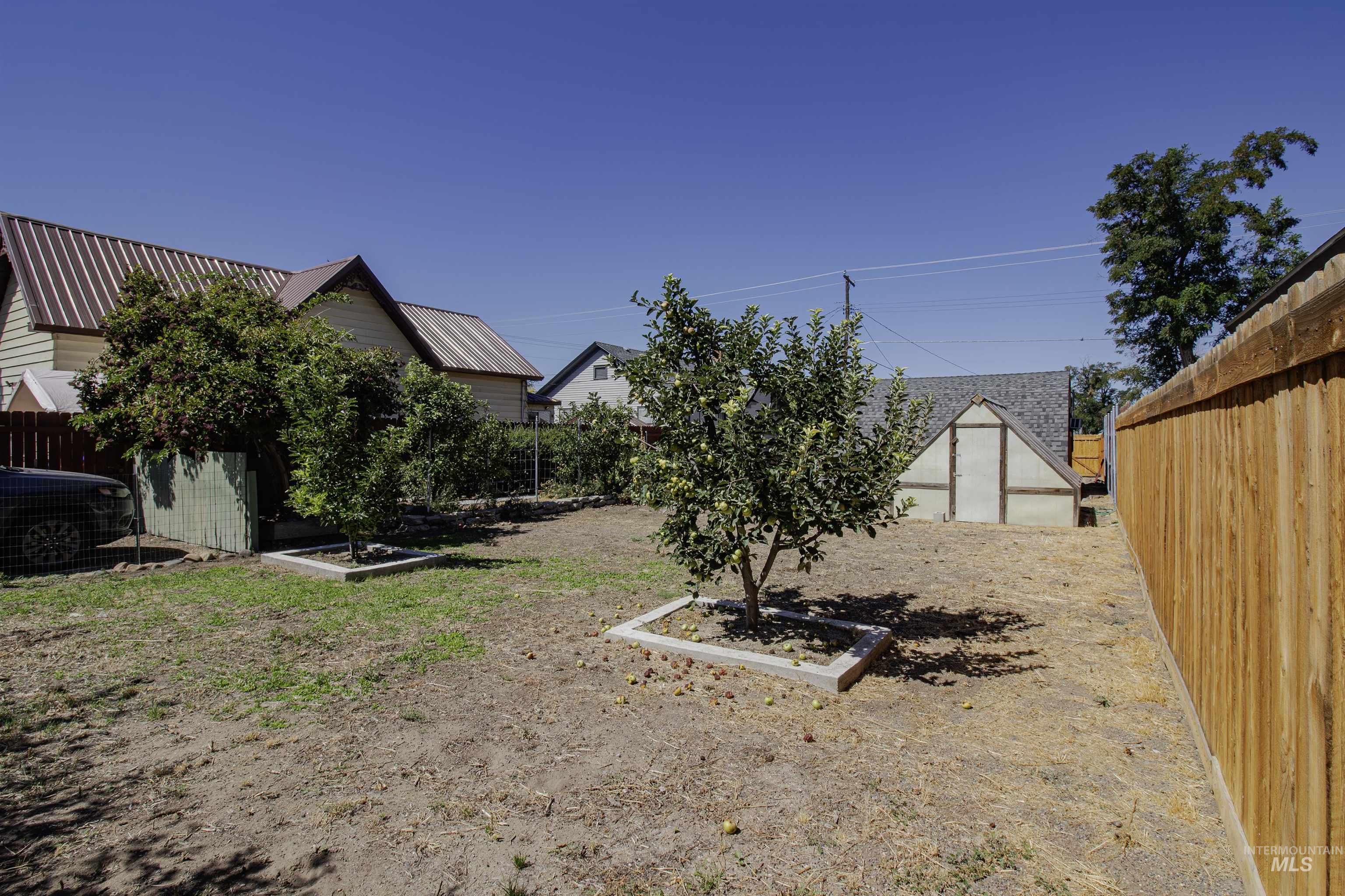 161 Southeast 5th Avenue Ontario, OR 97914 - Photo 32 of 41 Fenced backyard featuring an outbuilding and a garden