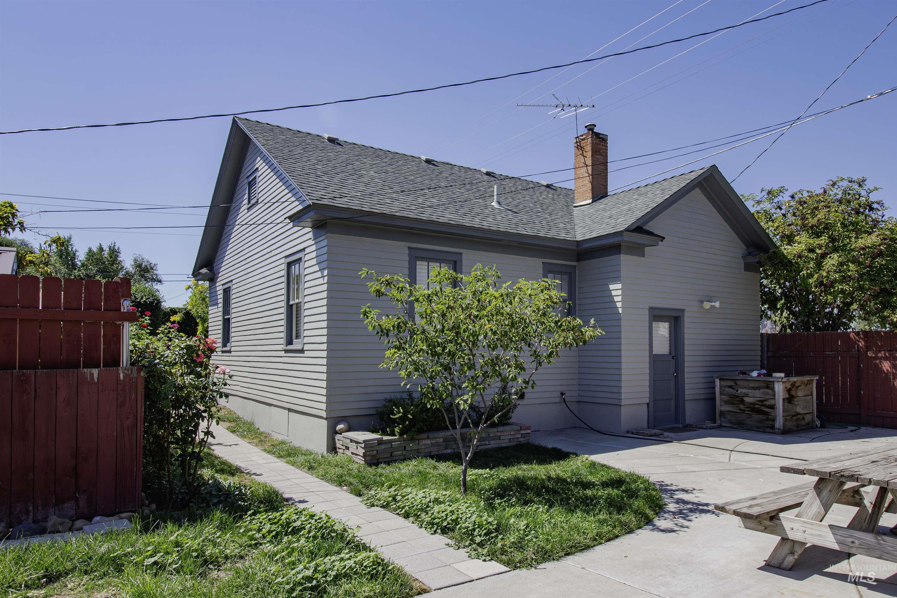 161 Southeast 5th Avenue Ontario, OR 97914 - Photo 33 of 41 View of front of property featuring roof with shingles, a chimney, and a patio
