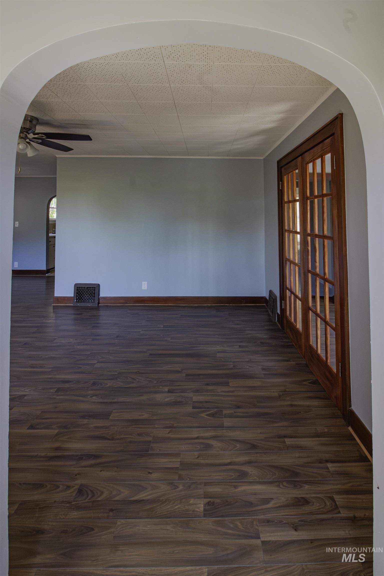 161 Southeast 5th Avenue Ontario, OR 97914 - Photo 41 of 41 Spare room with arched walkways, dark wood-type flooring, french doors, and ceiling fan