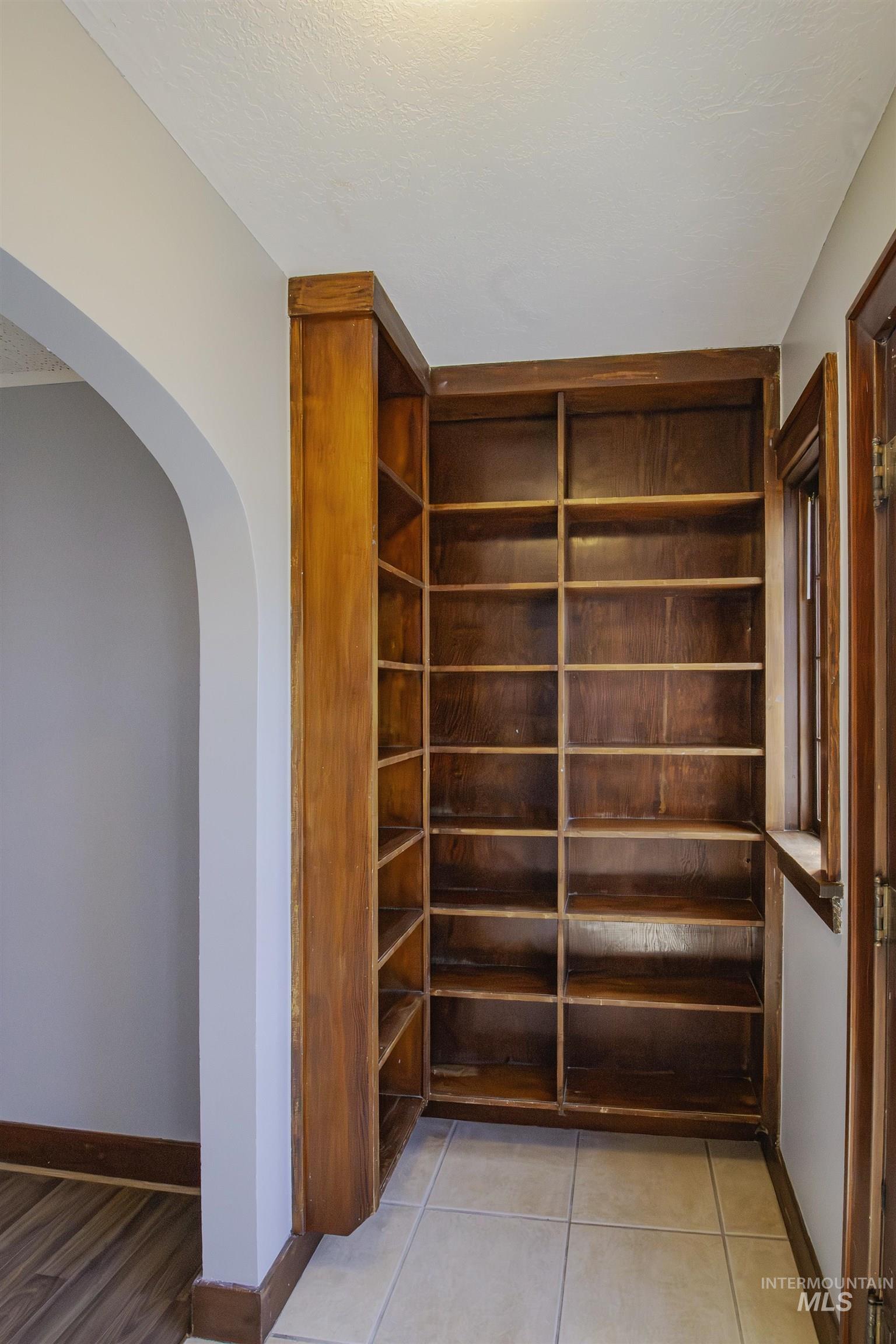 161 Southeast 5th Avenue Ontario, OR 97914 - Photo 5 of 41 Entry featuring arched walkway, wood shelving and light tile patterned floors