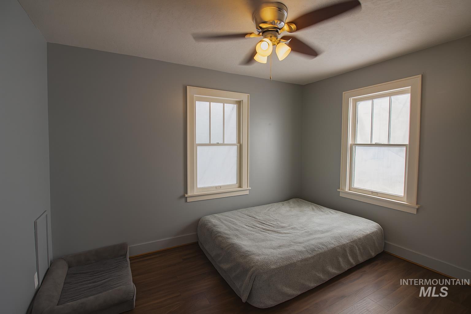 161 Southeast 5th Avenue Ontario, OR 97914 - Photo 7 of 41 Bedroom featuring wood finished floors and ceiling fan