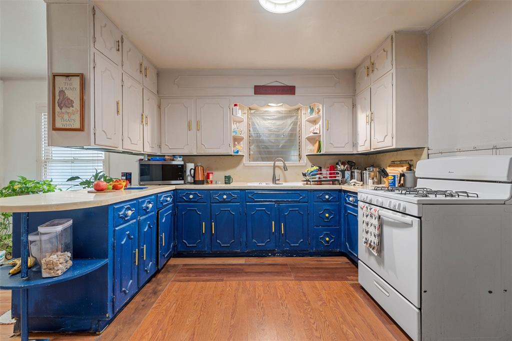 812 Hubert Street Waco, TX 76704 - Photo 15 of 22 a kitchen with granite countertop wooden cabinets and sink