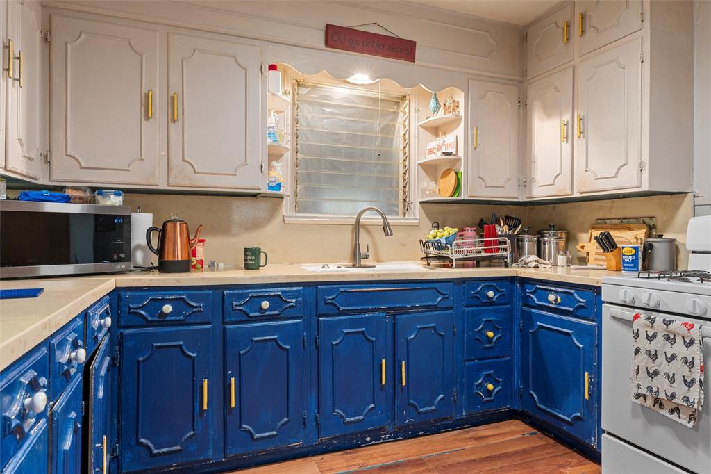812 Hubert Street Waco, TX 76704 - Photo 18 of 22 a kitchen with stainless steel appliances granite countertop wooden cabinets and sink