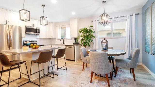 a spacious bedroom with a large bed and a dresser