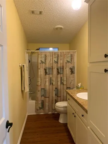 a bathroom with a double vanity sink toilet and shower