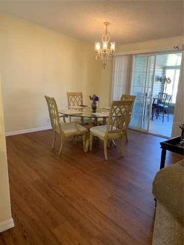 a view of a dining room with furniture and chandelier
