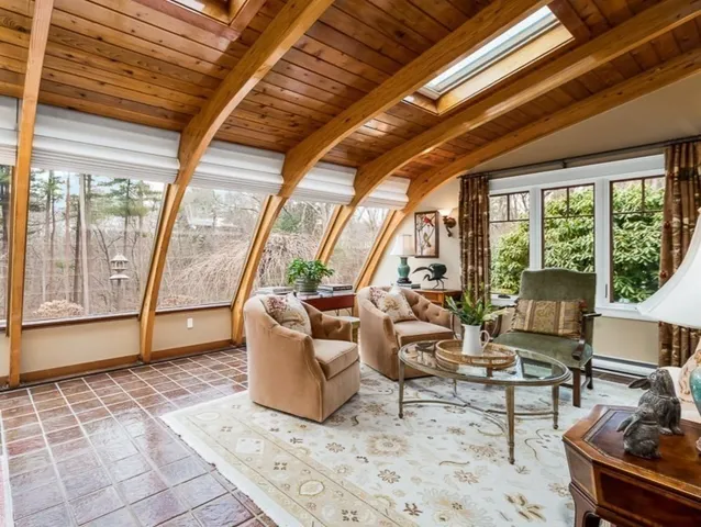 a living room with furniture and a floor to ceiling window