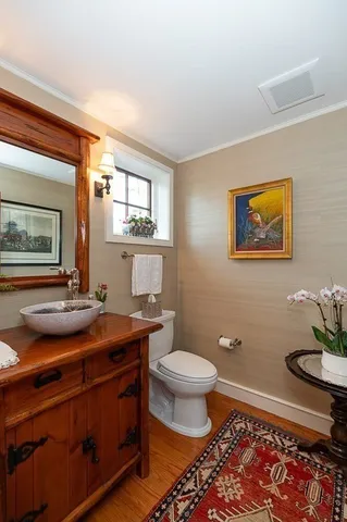 a bathroom with a granite countertop toilet sink and mirror