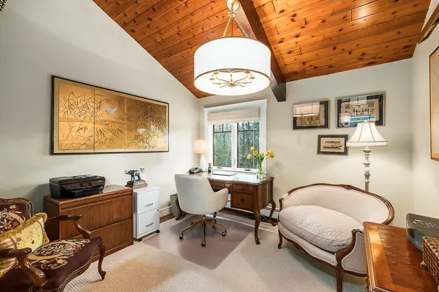 a living room with furniture a piano and a window