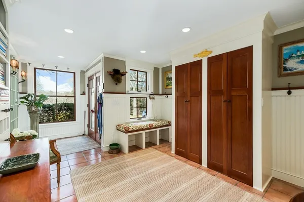 a living room with stainless steel appliances furniture and a kitchen view