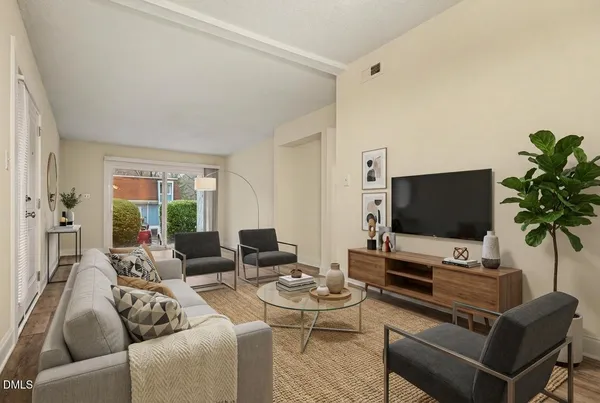 a living room with furniture and a flat screen tv