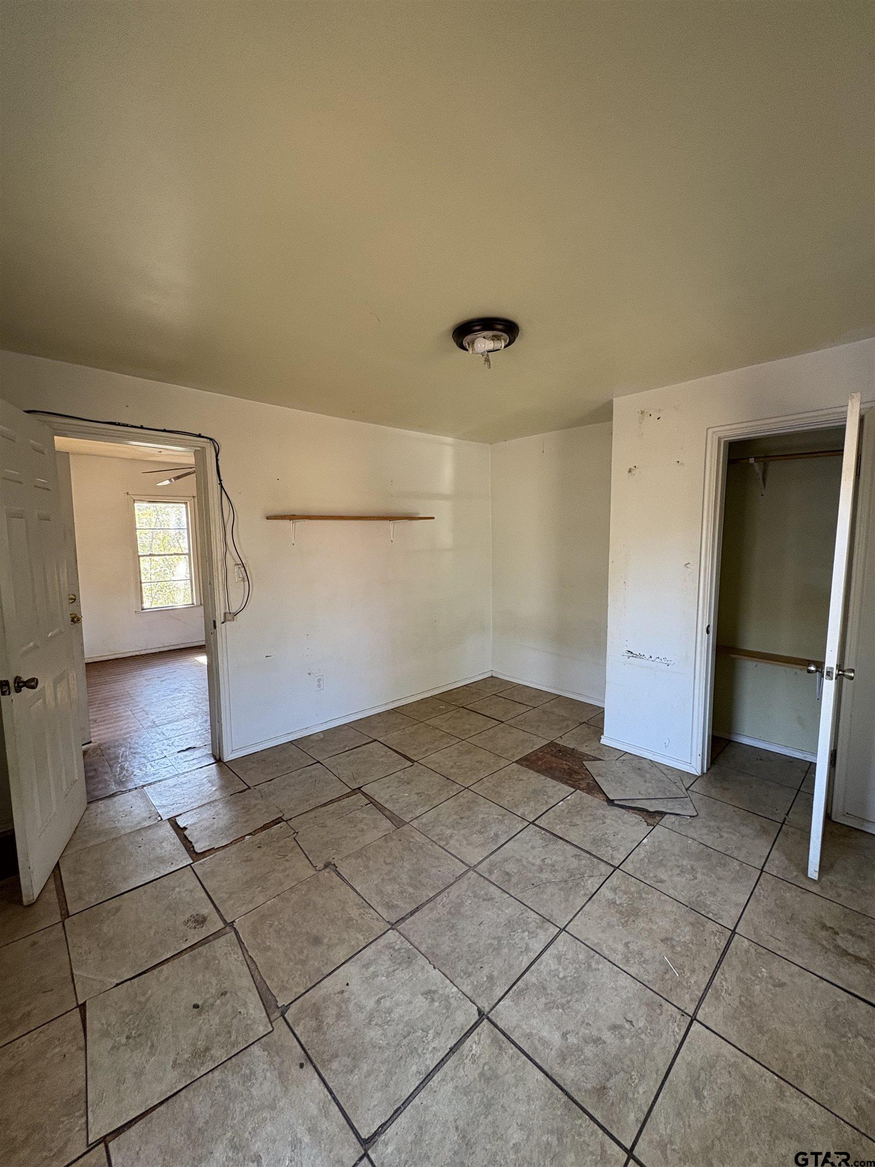166 Alvin Rusk, TX 75785 - Photo 3 of 8 a view of a livingroom with wooden floor and a refrigerator in a kitchen