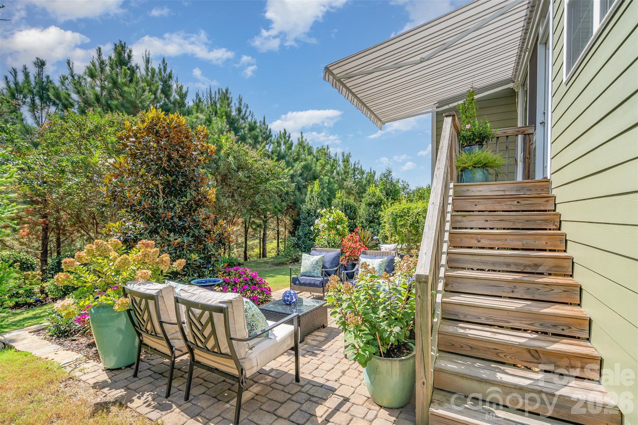 1627 Tranquility Boulevard Lancaster, SC 29720 - Photo 23 of 40 a patio with table and chairs and potted plants