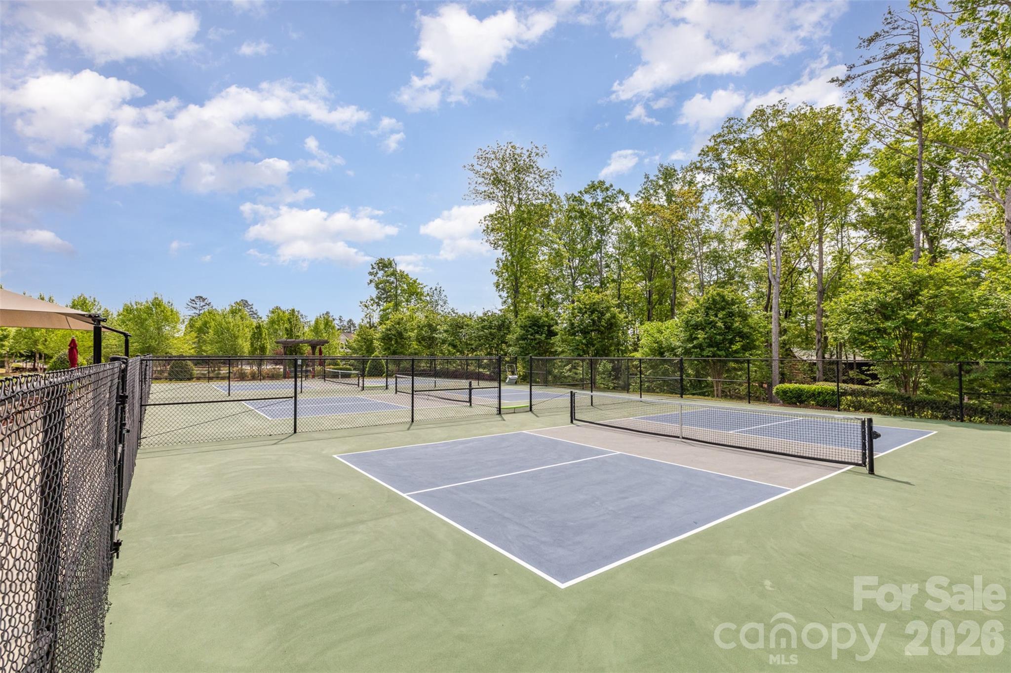 1627 Tranquility Boulevard Lancaster, SC 29720 - Photo 34 of 40 a tennis court with trees in the background