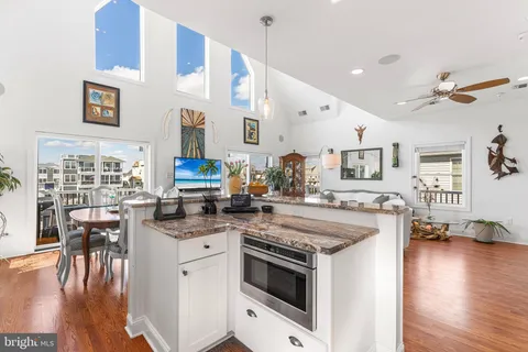 a kitchen with a stove and a wooden floors