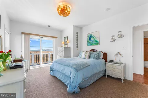 a spacious bedroom with a bed and a window