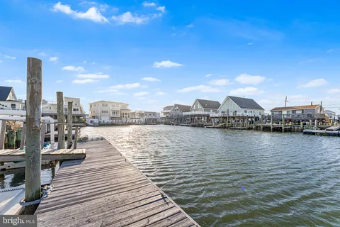a view of a ocean with boats and trees in the background
