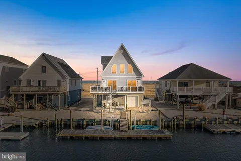 a view of a big house with a big yard and large trees
