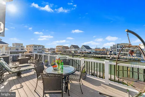 a view of a chairs and table in the balcony