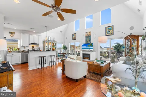 a living room with furniture and kitchen view