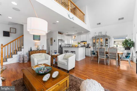 a living room with furniture kitchen view and a dining table