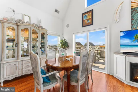a view of a dining room with furniture a chandelier and wooden floor