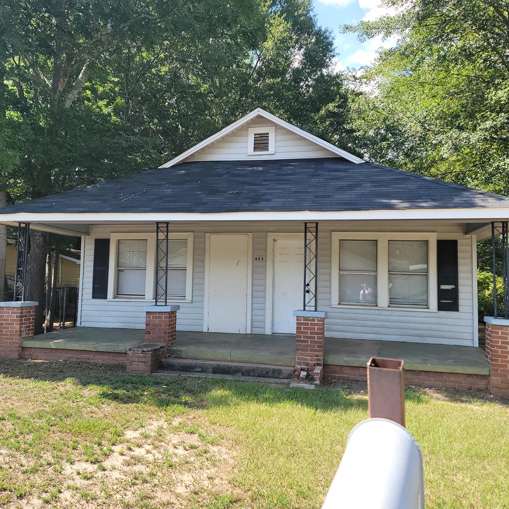 a front view of a house with a yard table and chairs