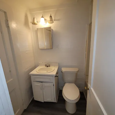 a bathroom with a toilet sink and mirror