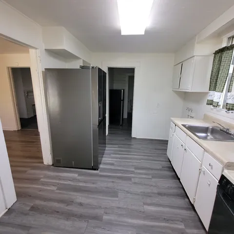 a kitchen with stainless steel appliances granite countertop a refrigerator and a sink