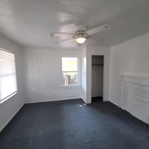 an empty room with a empty space and windows