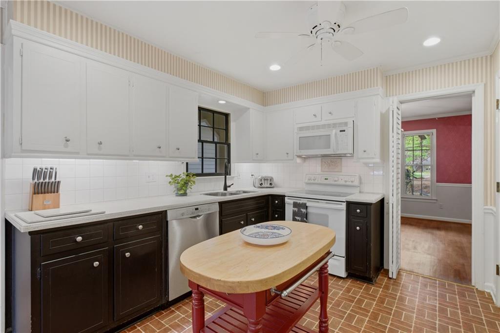 7245 Dunhill Terrace Northeast Atlanta, GA 30328 - Photo 13 of 45 a kitchen with a sink stove and white cabinets