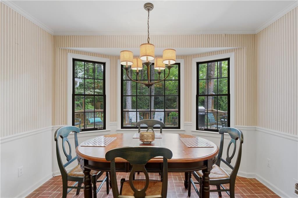 7245 Dunhill Terrace Northeast Atlanta, GA 30328 - Photo 14 of 45 a dining room with furniture large windows and a chandelier