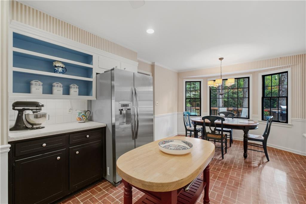 7245 Dunhill Terrace Northeast Atlanta, GA 30328 - Photo 15 of 45 a kitchen with stainless steel appliances granite countertop a dining table chairs and granite counter tops