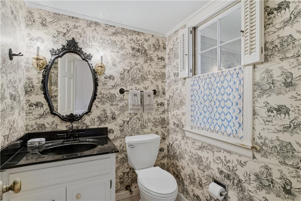 7245 Dunhill Terrace Northeast Atlanta, GA 30328 - Photo 19 of 45 a bathroom with a toilet and a mirror